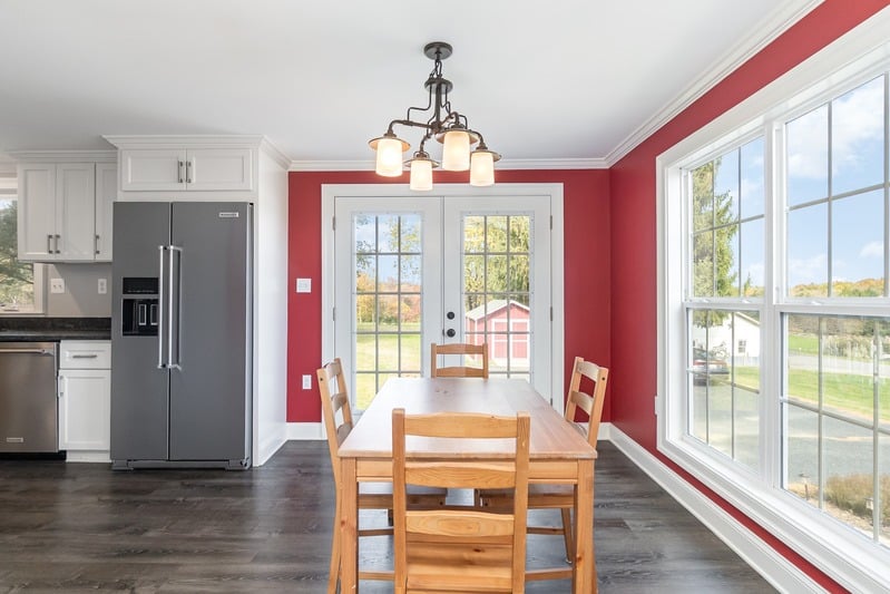 Bright dining room with kitchen and garden views